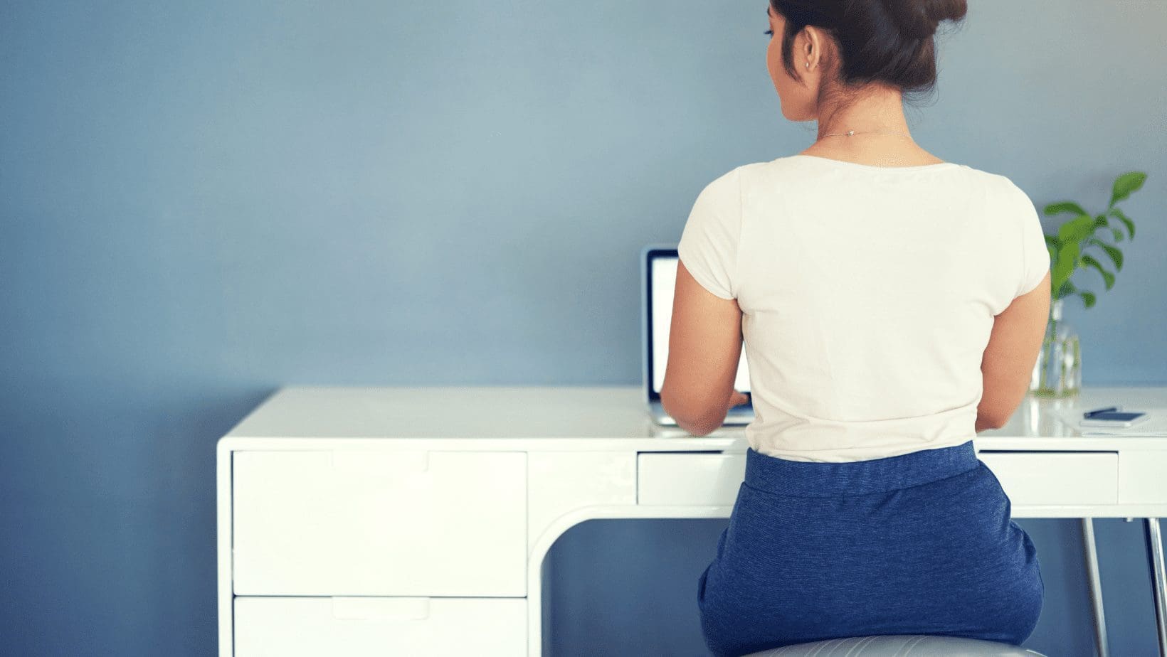woman sitting at desk with a laptop