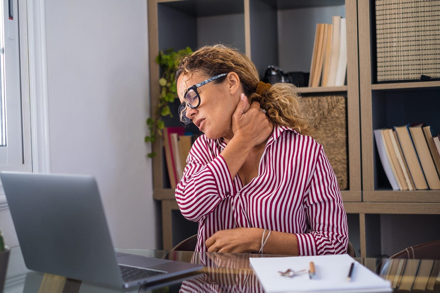 Office worker grabbing neck because of pinched nerves