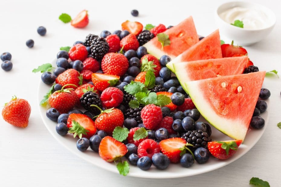 fruit and berry platter over white. blueberry, strawberry, raspberry, blackberry, watermelon
