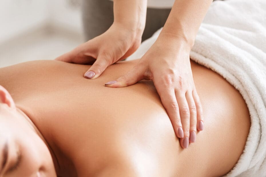 Women relaxing while receiving a massage, closeup.