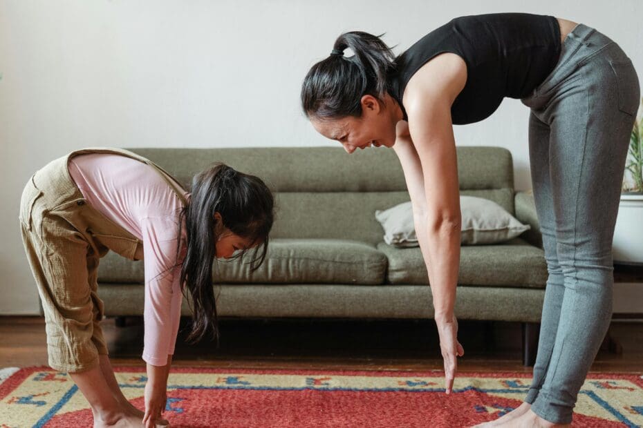 mother and daughter stretching in living room
