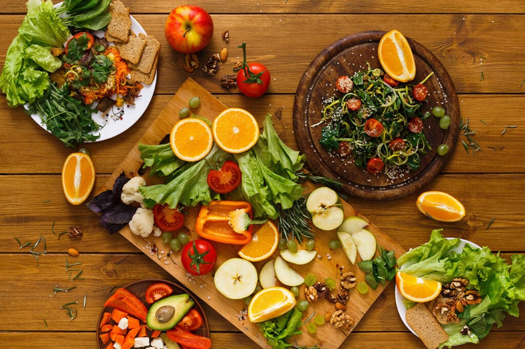 Variety of fruits and vegetables served on a wooden board