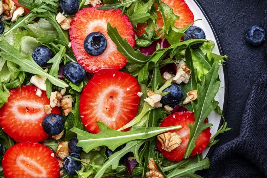 Fresh strawberry and herb salad on a white plate