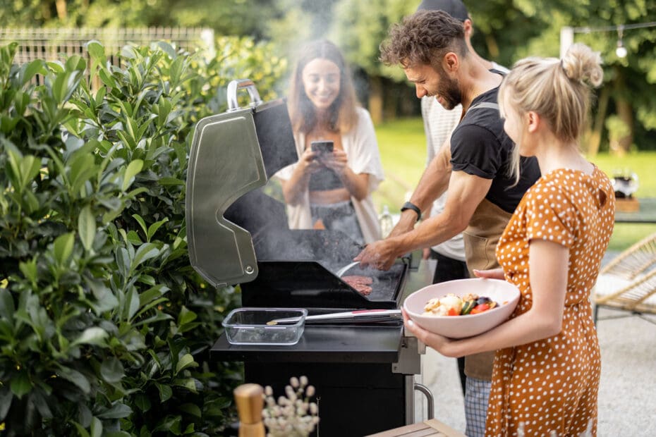 Young friends making a healthy meal at a summer cookout.